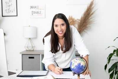 Headshot of woman writing on a calendar at a desk