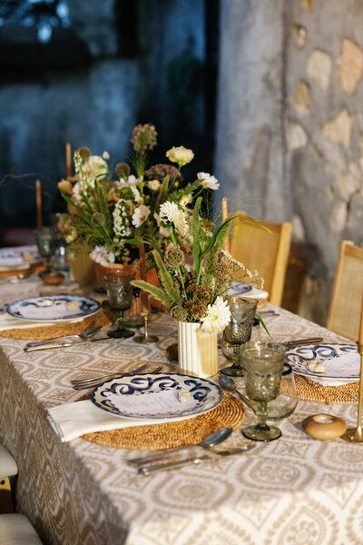Bold modern wedding tablescape with graphic patterned linens, colorful florals, taper candles, and eclectic place settings styled by Eventive Designs.