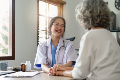 Doctor comforting elderly patient