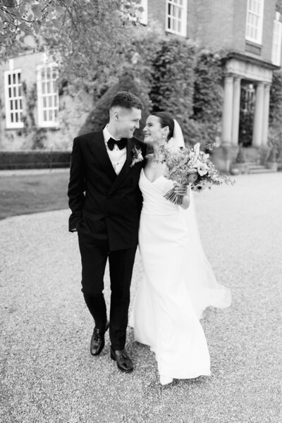 a wedding couple embracing at their wedding in ireland at adare manor