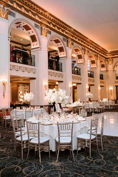 Charming wedding sweetheart table adorned with romantic floral garlands and cascading blooms by Leigh Florist.