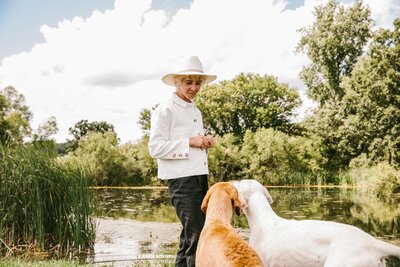 Sasha training two dogs to obey commands