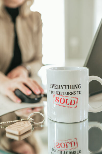 Real estate documents and coffee mug on a luxury countertop