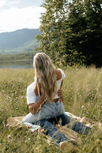 Moody and organic couples session in a field.