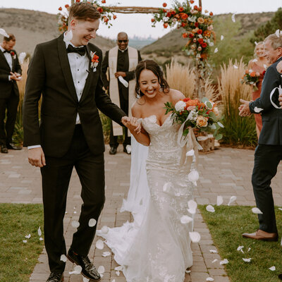 The bride and groom are so happy after they say I Do on their wedding day. They used rose petals as their send off from their ceremony at Manor House in Littleton, Colorado.