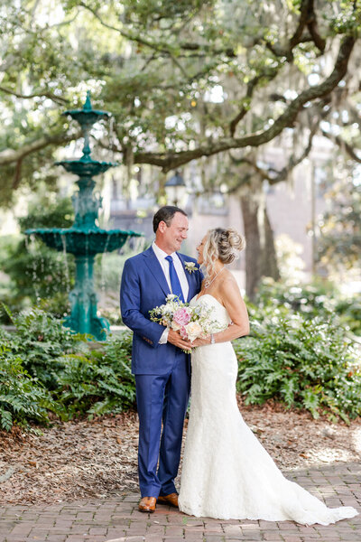 groom twirling bride in forsyth park after their elopement at the gastonian ins avannah