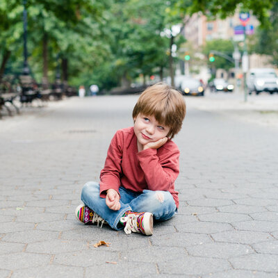 boy sitting on the ground