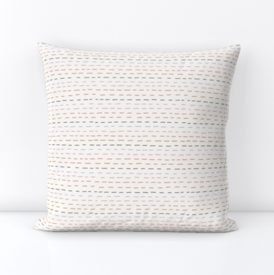 pillow with a pattern of multicolored dashed lines used as stripes, perfect with neutral decor, beach themes, feminine spaces, kids room,...
