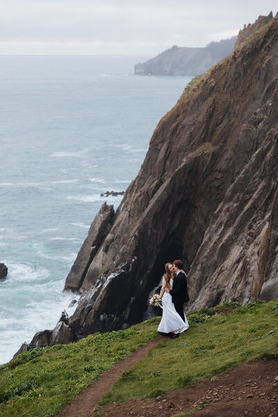 Couple holding hands walking together in fields of montana