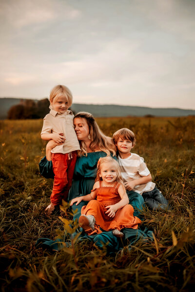 mom snuggling kids by harrisburg pa family photographer