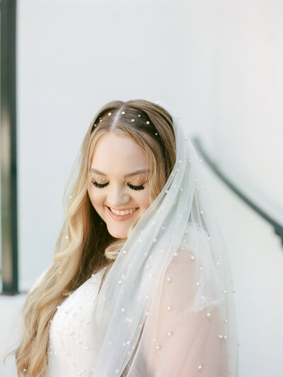 bride sneaking into the Mason Dallas bridal suite during her downtown dallas texas wedding