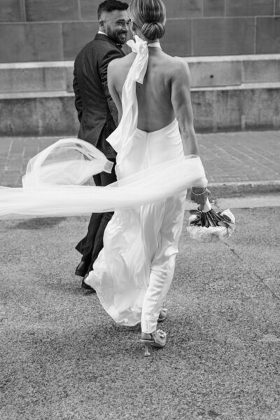 Wedding couple walking down street in Downtown Halifax, photographed by Rachael Shrum.