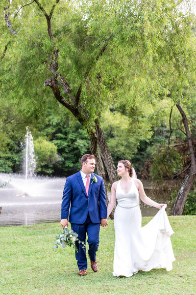 Bride and Groom walk together at classy wedding venue in raleigh north carolina