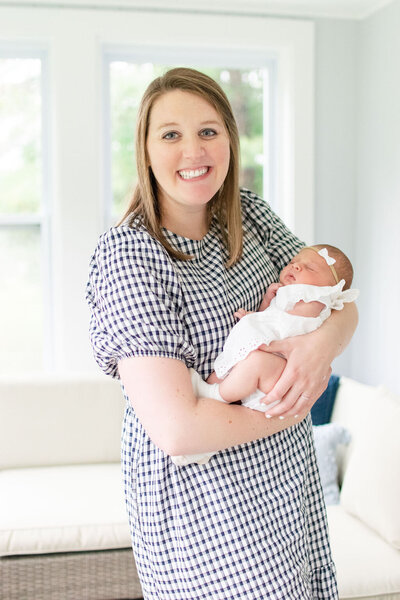 Best newborn photographer in Franklin, MA holding baby