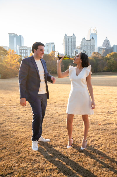 A couple shares a bottle of champagne at Piedmont Park in Atlanta, GA