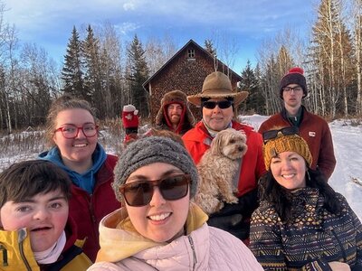Barb Drummond and family outside on a sunny, snowy day