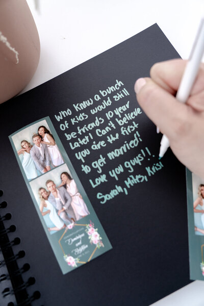 Printed photos from photo booth of best friends in a scrapbook with a message