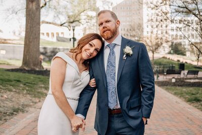 bride and groom walking and holding hands on their Hampton Roads wedding day