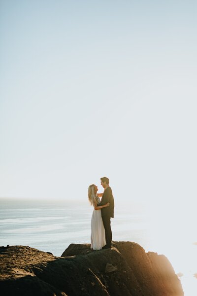 Bride and Groom on a rock overlooking water