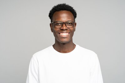 friendly-african-american-stylish-man-in-spectacles-wear-sweatshirt-smiling-broadly-standing-isolated_t20_lL7aAZ