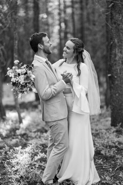 Black and white photo of a couple slow dancing during their wedding in Crested Butte, CO, capturing a timeless, romantic moment.