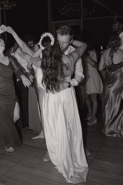 Couple dancing during the reception with all their people