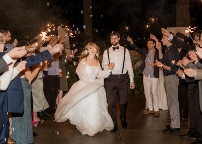 Couple doing their exit walk with bubbles and sparklers at Camp Colton.