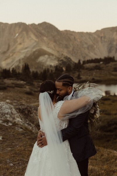 A bride and Groom hugging after their elopement at Loveland Pass