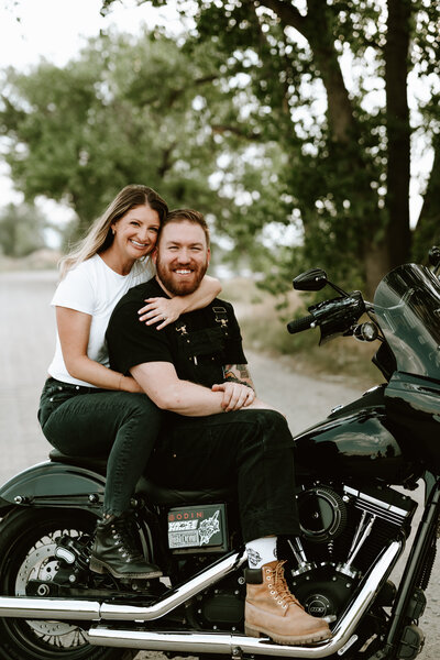 Engaged couple in Denver, Colorado, riding a motorcycle