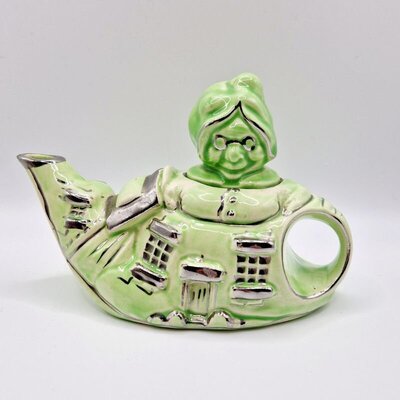vintage green teapot shaped like an old lady’s cottage, ceramic novelty design