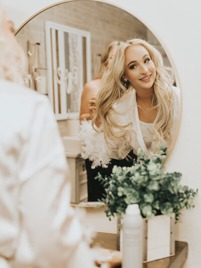Bride fixing her hair before her wedding day