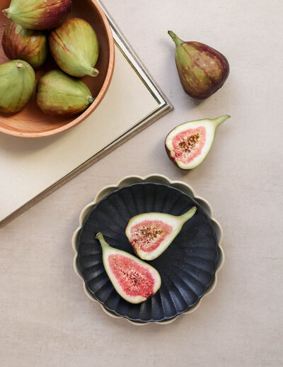 Styled flatlay with figs in an antique scalloped dish