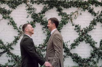 Emotional first look moment as Chris and Dave embrace on the rooftop of Quirk Hotel in Richmond before their ceremony.