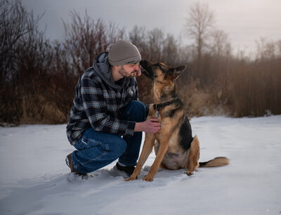 German Shepherd gives owner a kiss during a legacy rainbow bridge photo session. Captured during a pet session in Duluth, MN with Joanna of Paddle Paws Photography.