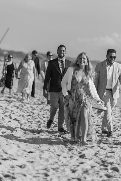 Wedding guests candid on the beach in Truro for chic LGBTQ wedding