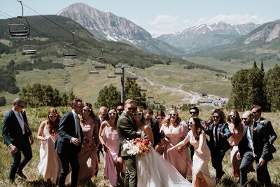 Bridal party in pink dresses and heart sunglasses celebrating a mountain wedding in Breckenridge, Colorado.
