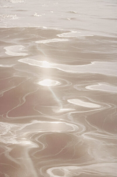 Light reflected off water, gives the illusion of blush coloured water