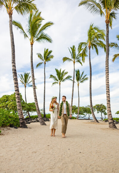 hawaii rainbow couples smiling at their maternity session on the beach