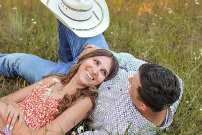 Katelynn and Kyle laying in grass for Couples Photoshoot