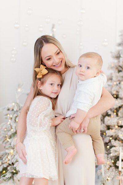 dad with son and daughter in front of the Christmas Tree by Miami Christmas Mini Session Photographer MSP