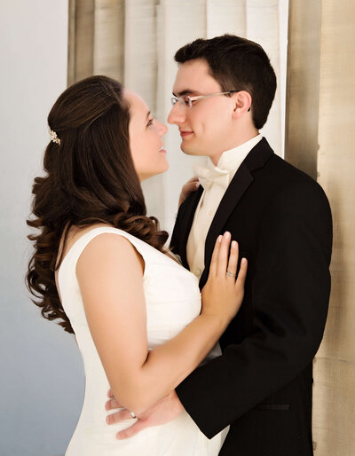 Photos of a bride and groom posing at the Erie Art Museum