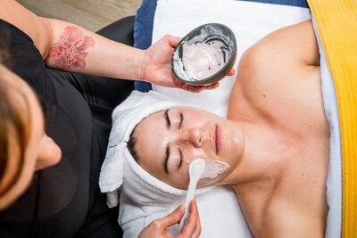 woman relaxing during facial mask apploication