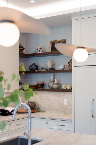 Renovated bathroom with marble walls and wooden cabinets