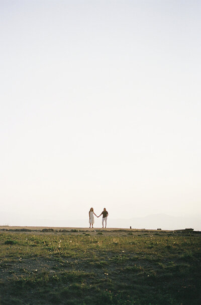 A couple holds hands for their editorial engagement session in Downtown Denver