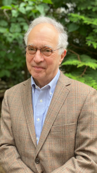 Website design client and author Fredric Schiffer in front of a tree. Dr. Schiffer is an elderly gentleman with white hair and glasses. He is the author of two books.