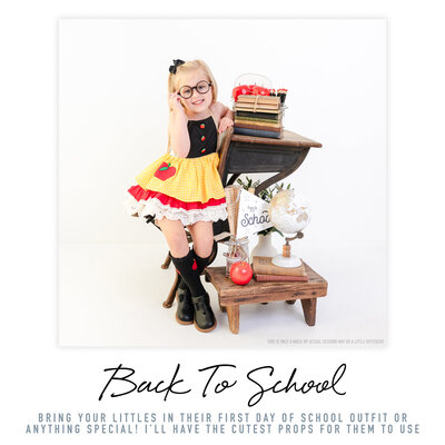 In the photo, a school-age girl is seated beside an antique desk, creating a captivating portrait. The white background creates a clean and pure aesthetic, allowing the attention to focus on the young girl's expressions and outfit. Shot by Bri Sullivan Photography, this photo showcases a classic and timeless style.