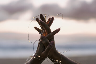 hands and string lights