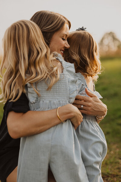 Mother embraces her two daughters in Minnesota photography session