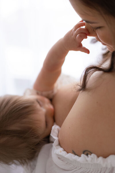 Toddler breastfeeding with her mother during NH breastfeeding milestone session, images by NH Baby Photographer