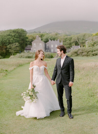 a bride and groom laughing during their romantic sunset photos